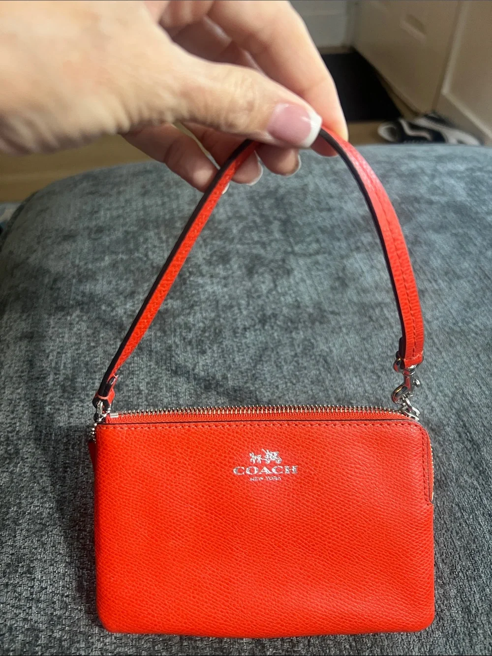 Coach orange/red Pebbled Leather wristlet.